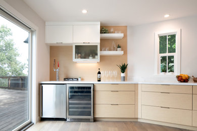 Example of a large minimalist light wood floor eat-in kitchen design in San Francisco with an undermount sink, flat-panel cabinets, light wood cabinets, quartz countertops, white backsplash, stone slab backsplash, stainless steel appliances, an island and white countertops