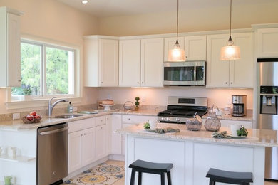 Small transitional l-shaped ceramic tile open concept kitchen photo in Detroit with shaker cabinets, white cabinets, granite countertops, beige backsplash, stainless steel appliances and an island