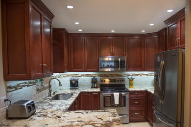 Example of a small classic u-shaped ceramic tile eat-in kitchen design in Miami with an undermount sink, flat-panel cabinets, dark wood cabinets, granite countertops, multicolored backsplash, mosaic tile backsplash, stainless steel appliances and a peninsula