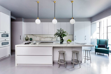 Inspiration for a large contemporary l-shaped gray floor kitchen remodel in London with flat-panel cabinets, solid surface countertops, white backsplash, stone slab backsplash, an island, white countertops, white cabinets and white appliances