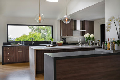 Eat-in kitchen - contemporary light wood floor, brown floor and vaulted ceiling eat-in kitchen idea in San Francisco with an undermount sink, flat-panel cabinets, dark wood cabinets, quartzite countertops, stainless steel appliances and two islands