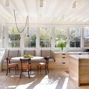 Scandinavian eat-in kitchen pictures - Inspiration for a scandinavian light wood floor and beige floor eat-in kitchen remodel in Birmingham with flat-panel cabinets, light wood cabinets, stainless steel appliances, an island and white countertops