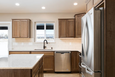 Inspiration for a mid-sized transitional l-shaped eat-in kitchen remodel in Other with an undermount sink, flat-panel cabinets, medium tone wood cabinets, quartz countertops, white backsplash, ceramic backsplash, stainless steel appliances, an island and beige countertops