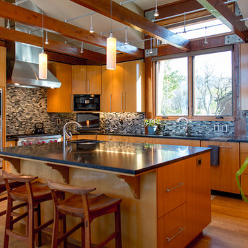 Honed granite and glass backsplash in kitchen