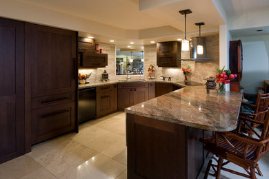 Photo of a small world-inspired u-shaped kitchen/diner in Hawaii with shaker cabinets, dark wood cabinets, granite worktops, beige splashback, stone tiled splashback, integrated appliances, marble flooring and a breakfast bar.