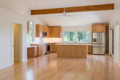 Large trendy l-shaped laminate floor eat-in kitchen photo in Hawaii with an undermount sink, shaker cabinets, light wood cabinets, quartz countertops, white backsplash, glass tile backsplash, stainless steel appliances and an island