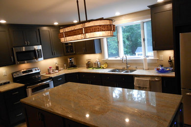Example of a large classic l-shaped light wood floor eat-in kitchen design in Boston with a double-bowl sink, shaker cabinets, gray cabinets, granite countertops, beige backsplash, stainless steel appliances, an island and beige countertops