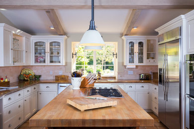 Inspiration for a large timeless u-shaped terra-cotta tile kitchen remodel in Santa Barbara with stone tile backsplash and stainless steel appliances