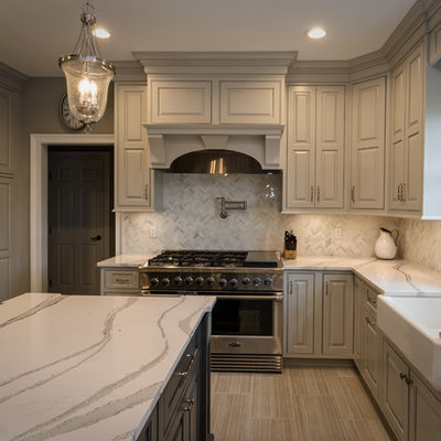 Eat-in kitchen - large traditional u-shaped ceramic tile and beige floor eat-in kitchen idea in New York with a farmhouse sink, beaded inset cabinets, gray cabinets, quartz countertops, stainless steel appliances, an island, white backsplash, marble backsplash and white countertops