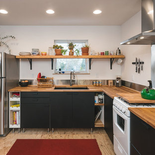 Inspiration for a contemporary l-shaped kitchen in Portland with wood benchtops, metallic splashback, plywood floors, a double-bowl sink, brown floor and brown benchtop.