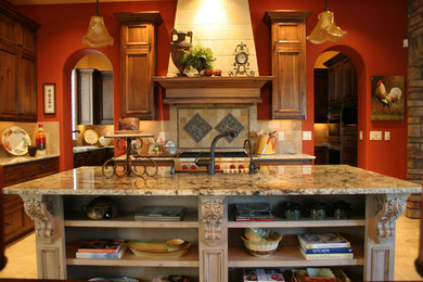 Inspiration for a mediterranean kitchen remodel in Boise with granite countertops, beige backsplash and an island