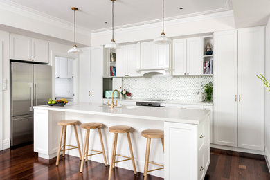 Inspiration for a medium sized coastal l-shaped open plan kitchen in Perth with a double-bowl sink, shaker cabinets, white cabinets, multi-coloured splashback, stainless steel appliances, dark hardwood flooring, an island and brown floors.