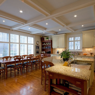 Example of a classic eat-in kitchen design in Toronto with stainless steel appliances and beige backsplash