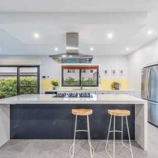 Mid-sized contemporary kitchen in Canberra - Queanbeyan with a double-bowl sink, white cabinets, quartz benchtops, yellow splashback, with island and white benchtop.