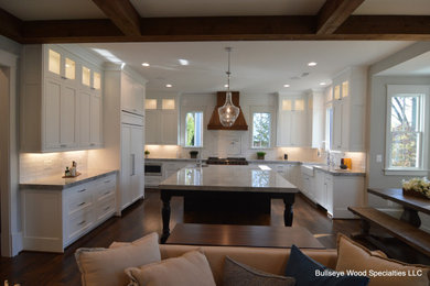 Huge arts and crafts u-shaped dark wood floor and brown floor open concept kitchen photo in DC Metro with a farmhouse sink, shaker cabinets, white cabinets, granite countertops, white backsplash, subway tile backsplash, paneled appliances, an island and gray countertops