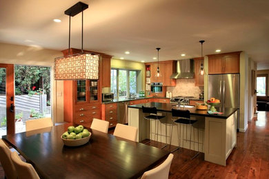 Mid-sized trendy l-shaped medium tone wood floor eat-in kitchen photo in San Francisco with an undermount sink, recessed-panel cabinets, medium tone wood cabinets, stainless steel appliances and an island