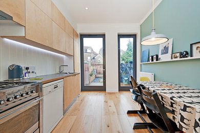 Photo of a contemporary galley kitchen/diner in Kent with flat-panel cabinets.