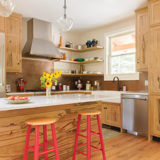 This is an example of a mid-sized country l-shaped kitchen in Nashville with a farmhouse sink, shaker cabinets, medium wood cabinets, quartz benchtops, metallic splashback, stainless steel appliances, with island, brown floor, white benchtop, metal splashback and medium hardwood floors.