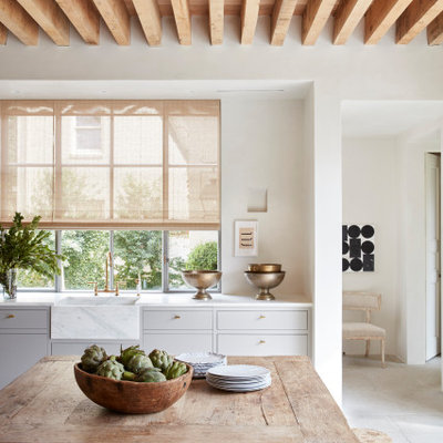 Eat-in kitchen - large transitional l-shaped gray floor and wood ceiling eat-in kitchen idea in Houston with a farmhouse sink, flat-panel cabinets, gray cabinets and white countertops