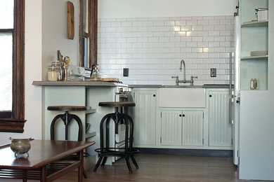 Inspiration for a large victorian u-shaped open plan kitchen in New York with a belfast sink, louvered cabinets, green cabinets, wood worktops, white splashback, stone tiled splashback, white appliances, dark hardwood flooring and a breakfast bar.