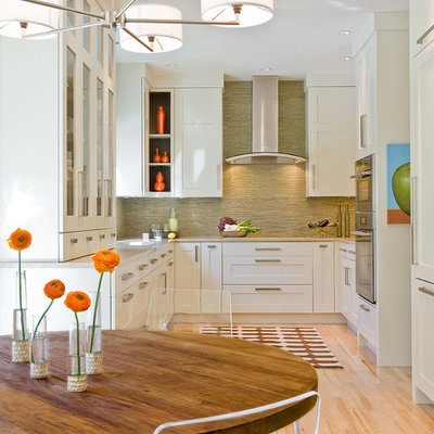 Eat-in kitchen - transitional u-shaped eat-in kitchen idea in Boston with shaker cabinets, paneled appliances, white cabinets, green backsplash and matchstick tile backsplash