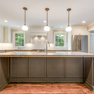 Large farmhouse open concept kitchen designs - Inspiration for a large farmhouse l-shaped medium tone wood floor and brown floor open concept kitchen remodel in Cleveland with an undermount sink, recessed-panel cabinets, white cabinets, granite countertops, white backsplash, subway tile backsplash, stainless steel appliances, an island and multicolored countertops