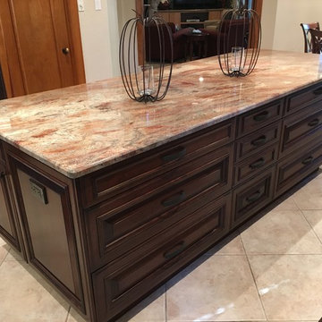 Huge custom cherry island features lots of drawers and a huge work surface of Cr