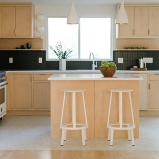 Mid-sized scandinavian open concept kitchen pictures - Example of a mid-sized danish l-shaped concrete floor and white floor open concept kitchen design in Los Angeles with beige cabinets, green backsplash, ceramic backsplash, white appliances, an island and white countertops