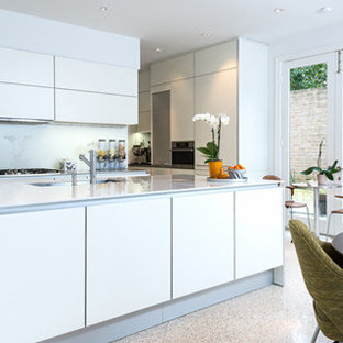 Design ideas for a mid-sized midcentury kitchen pantry in Houston with an undermount sink, louvered cabinets, white cabinets, recycled glass benchtops, white splashback, matchstick tile splashback, panelled appliances and slate floors.
