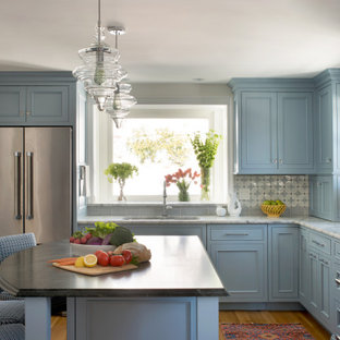 This is an example of a mid-sized traditional l-shaped kitchen in Boston with an undermount sink, beaded inset cabinets, blue cabinets, quartz benchtops, blue splashback, ceramic splashback, stainless steel appliances, with island, brown floor, grey benchtop and medium hardwood floors.