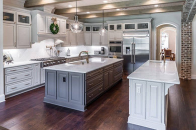 Kitchen - traditional l-shaped kitchen idea in New Orleans with two islands