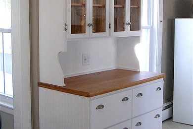 Mid-sized farmhouse ceramic tile and beige floor kitchen photo in Boston with flat-panel cabinets, white cabinets and wood countertops