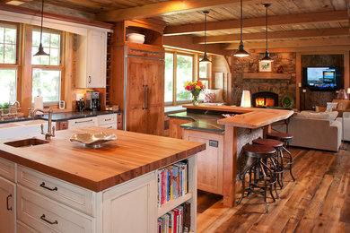 Open concept kitchen - large rustic l-shaped medium tone wood floor open concept kitchen idea in Other with a farmhouse sink, shaker cabinets, medium tone wood cabinets, wood countertops, stainless steel appliances, two islands and wood backsplash