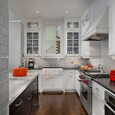 Inspiration for a transitional kitchen remodel in Chicago with a farmhouse sink, quartzite countertops, gray backsplash, glass tile backsplash and stainless steel appliances
