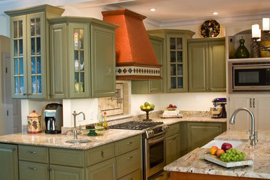 Example of a classic kitchen design in Raleigh with a farmhouse sink, granite countertops, stainless steel appliances and green cabinets