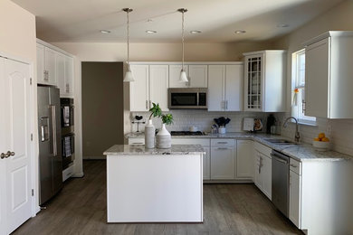 Mid-sized trendy u-shaped medium tone wood floor and gray floor eat-in kitchen photo in Baltimore with a double-bowl sink, shaker cabinets, white cabinets, granite countertops, white backsplash, subway tile backsplash, stainless steel appliances, an island and gray countertops