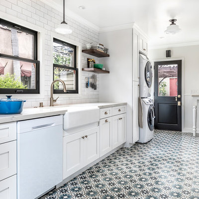 Inspiration for a mid-sized country galley cement tile floor and multicolored floor enclosed kitchen remodel in Los Angeles with white cabinets, marble countertops, white backsplash, ceramic backsplash, white appliances, no island, a farmhouse sink and shaker cabinets