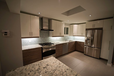 Open concept kitchen - mid-sized contemporary l-shaped ceramic tile open concept kitchen idea in Toronto with an undermount sink, flat-panel cabinets, white cabinets, quartz countertops, multicolored backsplash, mosaic tile backsplash, stainless steel appliances and an island