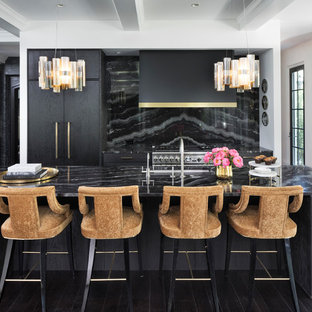 Inspiration for a mediterranean kitchen in Minneapolis with an undermount sink, flat-panel cabinets, dark wood cabinets, black splashback, stainless steel appliances, dark hardwood floors, with island and brown floor.