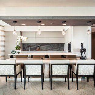 Contemporary kitchen pictures - Example of a trendy kitchen design in Miami with flat-panel cabinets, beige cabinets, multicolored backsplash and stainless steel appliances