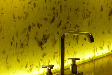 Illuminated kitchen backsplash with rice paper leaves into laminated glass