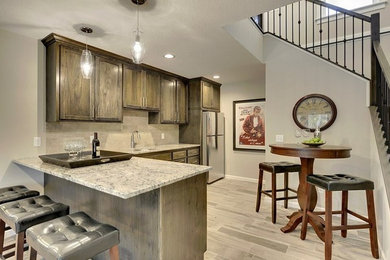 Eat-in kitchen - mid-sized rustic l-shaped porcelain tile eat-in kitchen idea in Minneapolis with an undermount sink, shaker cabinets, dark wood cabinets, granite countertops, beige backsplash, ceramic backsplash, stainless steel appliances and a peninsula