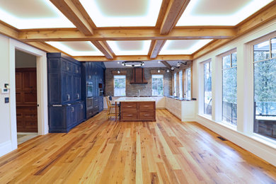 Example of a huge transitional u-shaped medium tone wood floor and multicolored floor eat-in kitchen design in Boston with a farmhouse sink, beaded inset cabinets, marble countertops, multicolored backsplash, brick backsplash, stainless steel appliances, an island and multicolored countertops