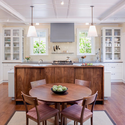 Example of a transitional galley eat-in kitchen design in San Francisco with glass-front cabinets, white cabinets and beige backsplash