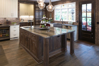 Inspiration for a mid-sized industrial kitchen pantry remodel in Atlanta with a farmhouse sink, beaded inset cabinets, quartzite countertops, brick backsplash, stainless steel appliances and an island