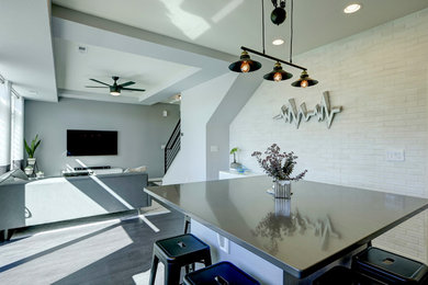 Eat-in kitchen - mid-sized contemporary l-shaped vinyl floor and black floor eat-in kitchen idea in Denver with an undermount sink, shaker cabinets, white cabinets, quartzite countertops, white backsplash, marble backsplash, stainless steel appliances and an island