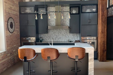 Example of a mid-sized urban single-wall porcelain tile and gray floor open concept kitchen design in Minneapolis with flat-panel cabinets, gray cabinets, quartz countertops, marble backsplash, stainless steel appliances, two islands and white countertops