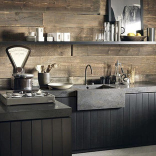 Inspiration for a small industrial l-shaped eat-in kitchen in Columbus with an integrated sink, flat-panel cabinets, black cabinets, concrete benchtops, brown splashback, timber splashback, stainless steel appliances, concrete floors, a peninsula, grey floor and grey benchtop.