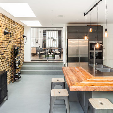 Industrial kitchen fulham with brick wall and critall style sliding doors