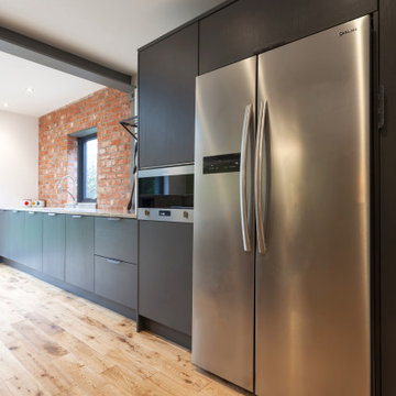 Industrial Kitchen With Exposed Brick & Stainless Steel Features